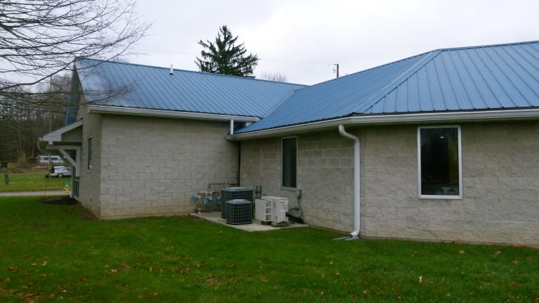 microscreen gutter guard installed on building with metal roof